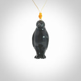 This pendant is a hand carved YELLOW EYED penguin. We've carved this from a lovely piece of black jade and we provide it with an adjustable cord. Shipping is free worldwide.